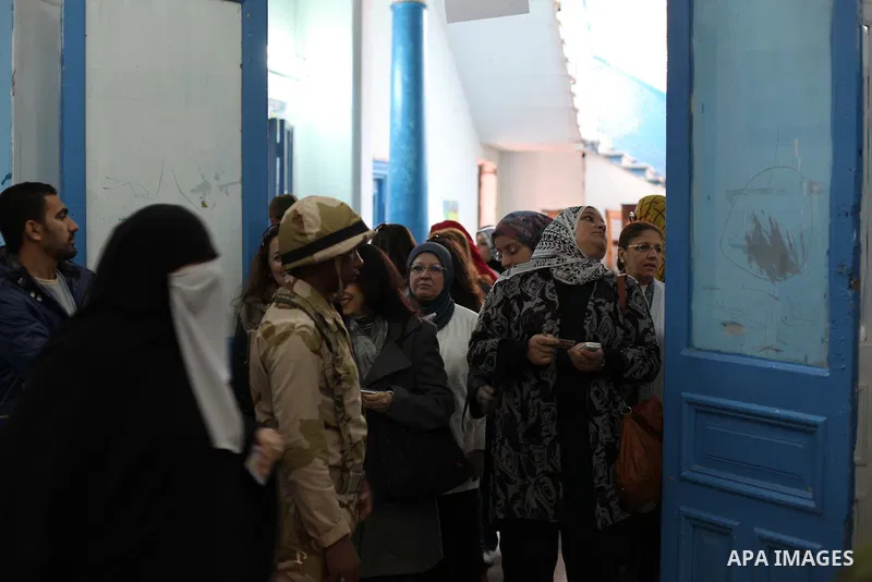 Egyptian women queue with other voters at a polling station during the second round of a referendum on a new draft constitution in Giza, south of Cairo, on December 22, 2012. Egyptians are voting in the final round of a...