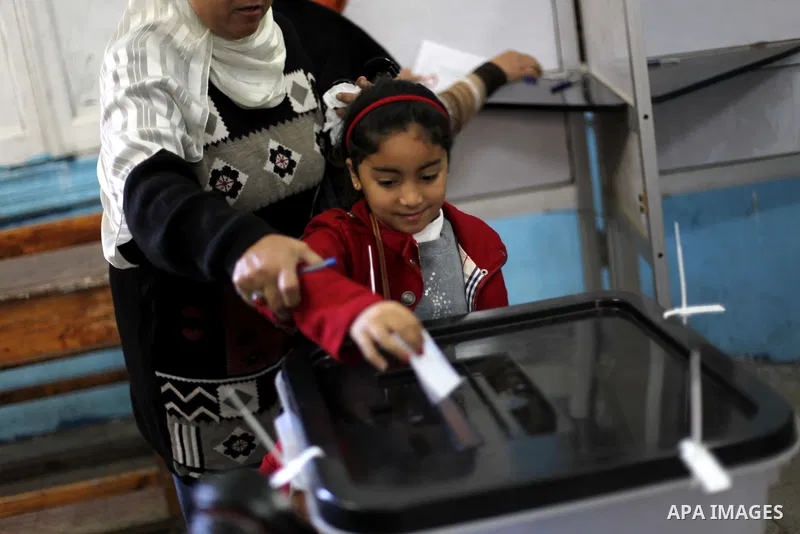 An Egyptian woman casts her ballot at a polling station during the second round of a referendum on a new draft constitution in Giza, south of Cairo, on December 22, 2012. Egyptians are voting in the final round of a refe...