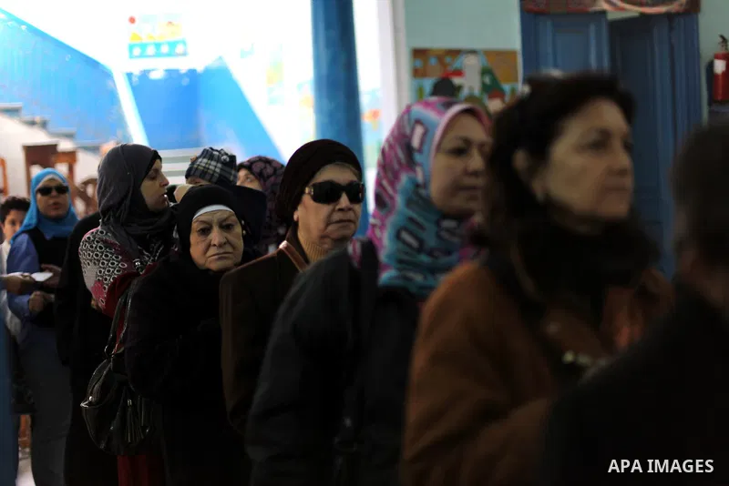 Egyptian women queue with other voters at a polling station during the second round of a referendum on a new draft constitution in Giza, south of Cairo, on December 22, 2012. Egyptians are voting in the final round of a...