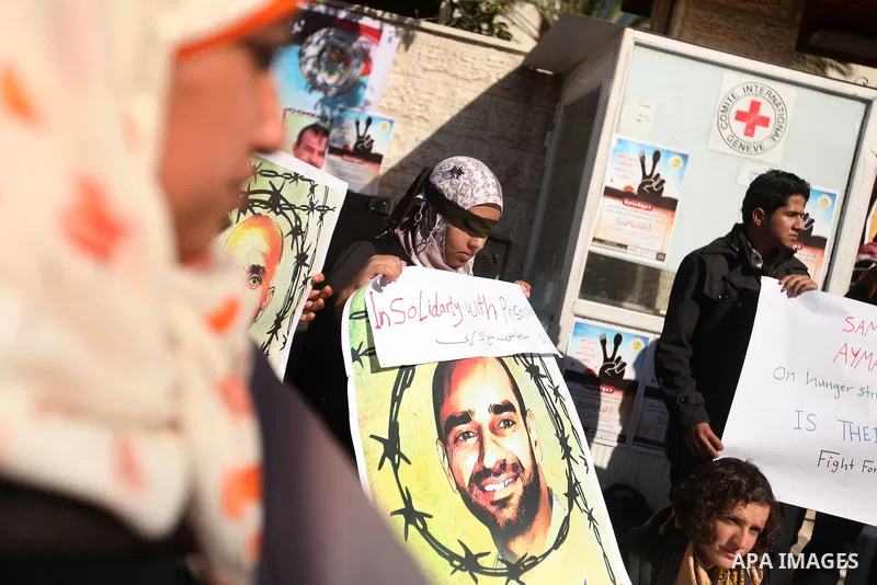 Palestinians who covered their eyes with black ribbons demonstrate in support of Palestinian prisoners held in Israeli jails, some of whom are observing a hunger strike, in Gaza City on December 22, 2012. Photo by Majdi...