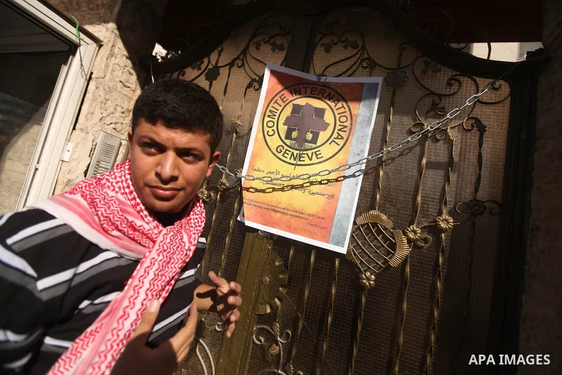 A Palestinian man lays posters demonstrate in support of Palestinian prisoners held in Israeli jails, some of whom are observing a hunger strike, in Gaza City on December 22, 2012. Photo by Majdi Fathi