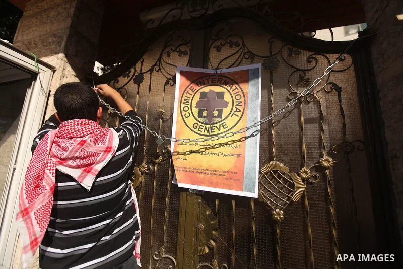 A Palestinian man lays posters demonstrate in support of Palestinian prisoners held in Israeli jails, some of whom are observing a hunger strike, in Gaza City on December 22, 2012. Photo by Majdi Fathi