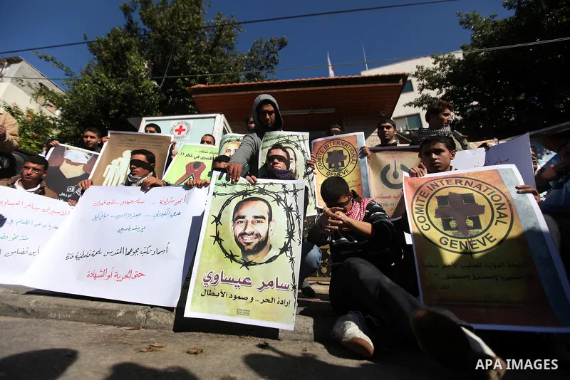 Palestinians who covered their eyes with black ribbons demonstrate in support of Palestinian prisoners held in Israeli jails, some of whom are observing a hunger strike, in Gaza City on December 22, 2012. Photo by Majdi...