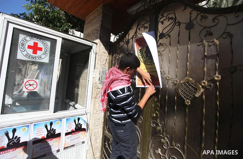 A Palestinian man lays posters demonstrate in support of Palestinian prisoners held in Israeli jails, some of whom are observing a hunger strike, in Gaza City on December 22, 2012. Photo by Majdi Fathi