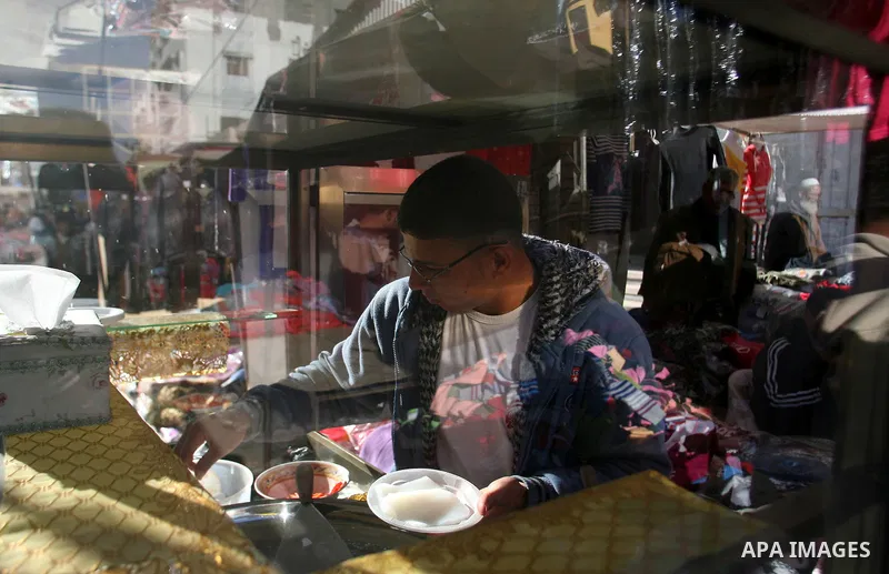 A Palestinian vendor sells sweets at the saturday's popular market in Rafah southern Gaza strip on 22 December 2012. Normal life in Gaza resumed remarkably fast after a ceasefire agreement was announced following eight d...