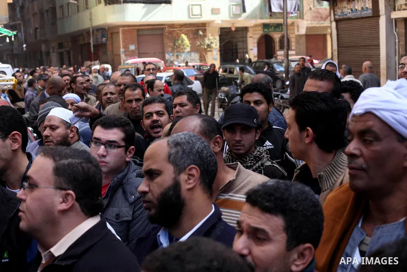 Egyptian voters gather at a polling station during the second round of a referendum on a new draft constitution in Giza, south of Cairo, on December 22, 2012. Egyptians are voting in the final round of a referendum on a...