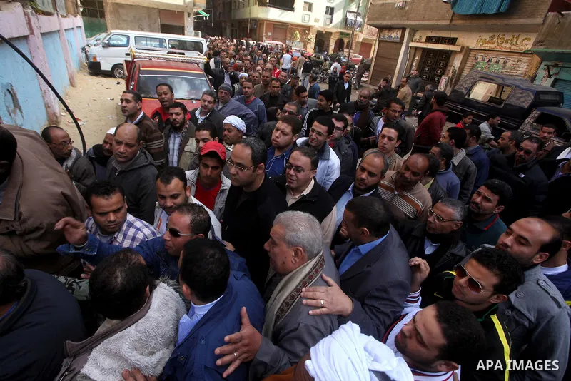 Egyptian voters gather at a polling station during the second round of a referendum on a new draft constitution in Giza, south of Cairo, on December 22, 2012. Egyptians are voting in the final round of a referendum on a...