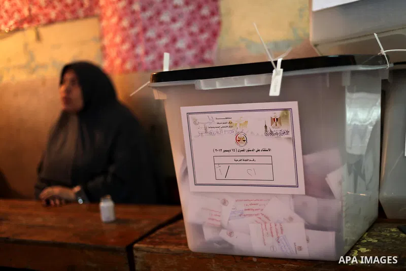 An Egyptian woman casts her ballot at a polling station during the second round of a referendum on a new draft constitution in Giza, south of Cairo, on December 22, 2012. Egyptians are voting in the final round of a refe...