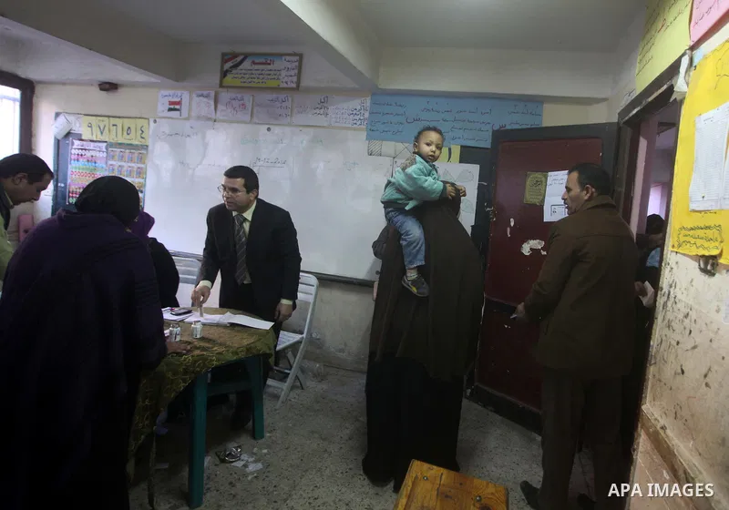 An Egyptian woman casts her ballot at a polling station during the second round of a referendum on a new draft constitution in Giza, south of Cairo, on December 22, 2012. Egyptians are voting in the final round of a refe...