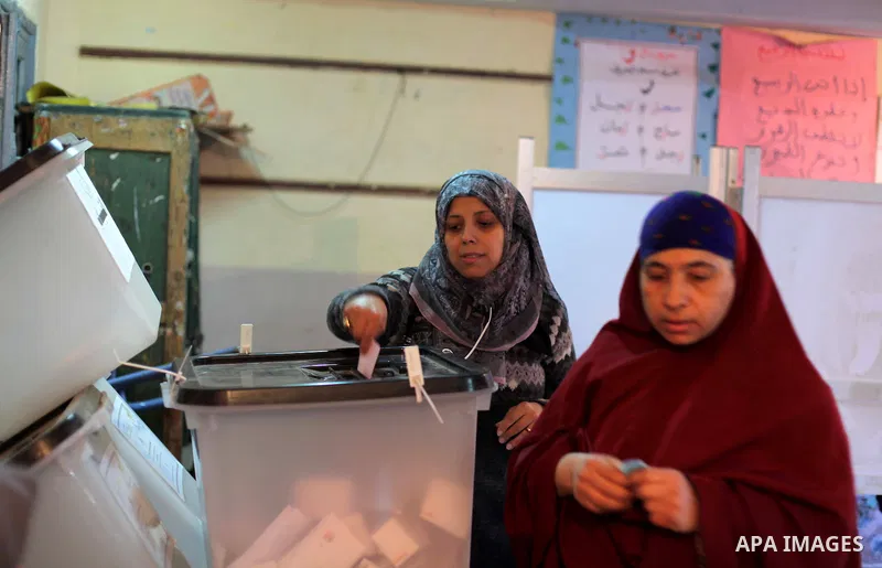 An Egyptian woman casts her ballot at a polling station during the second round of a referendum on a new draft constitution in Giza, south of Cairo, on December 22, 2012. Egyptians are voting in the final round of a refe...