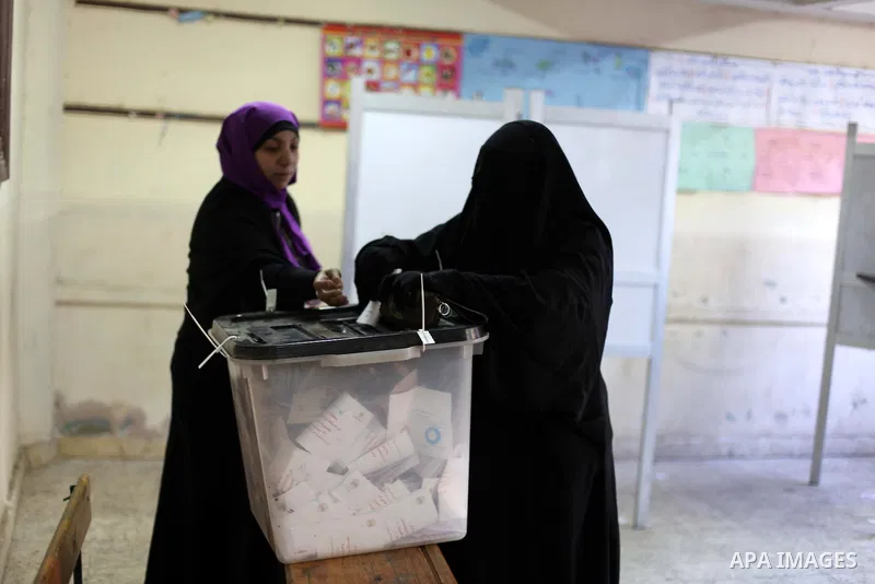 An Egyptian woman casts her ballot at a polling station during the second round of a referendum on a new draft constitution in Giza, south of Cairo, on December 22, 2012. Egyptians are voting in the final round of a refe...