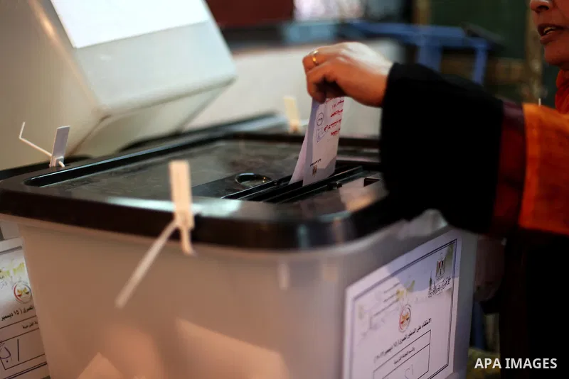 An Egyptian woman casts her ballot at a polling station during the second round of a referendum on a new draft constitution in Giza, south of Cairo, on December 22, 2012. Egyptians are voting in the final round of a refe...