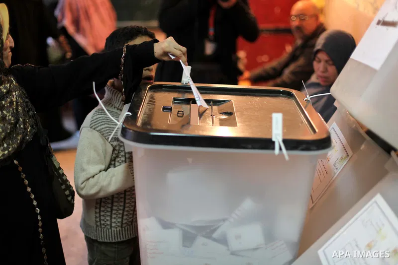 An Egyptian woman casts her ballot at a polling station during the second round of a referendum on a new draft constitution in Giza, south of Cairo, on December 22, 2012. Egyptians are voting in the final round of a refe...