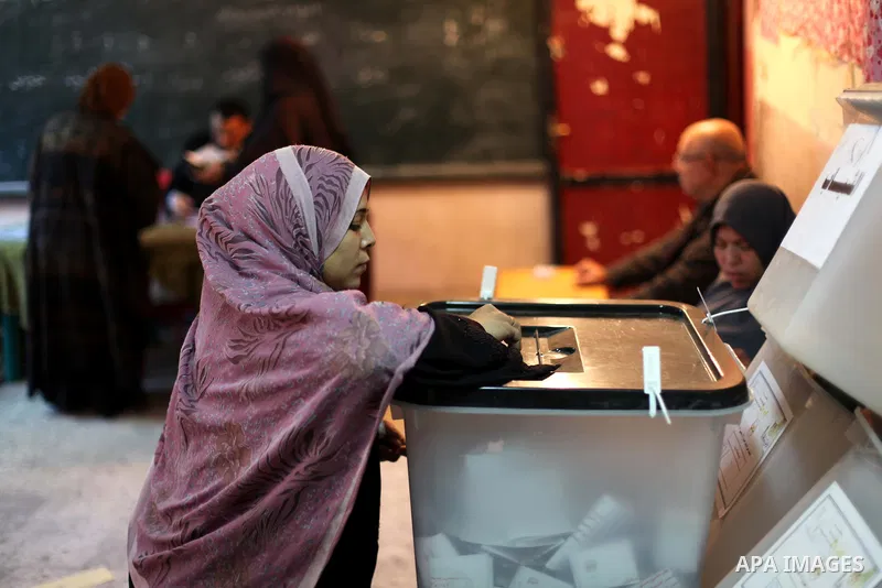 An Egyptian woman casts her ballot at a polling station during the second round of a referendum on a new draft constitution in Giza, south of Cairo, on December 22, 2012. Egyptians are voting in the final round of a refe...