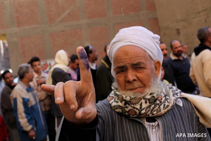 An Egyptian man shows his ink-stained finger after casting his vote in the final stage of a referendum draft constitution in Cairo, on December 22, 2012. Egyptians are voting in the final round of a referendum on a new c...