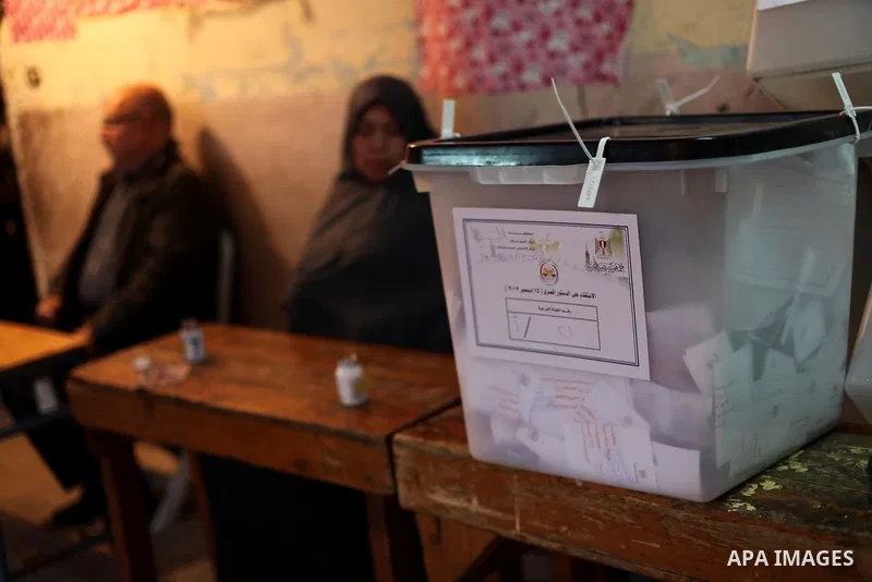 An Egyptian woman casts her ballot at a polling station during the second round of a referendum on a new draft constitution in Giza, south of Cairo, on December 22, 2012. Egyptians are voting in the final round of a refe...