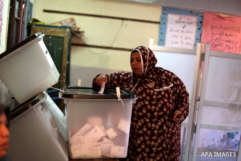 An Egyptian woman casts her ballot at a polling station during the second round of a referendum on a new draft constitution in Giza, south of Cairo, on December 22, 2012. Egyptians are voting in the final round of a refe...