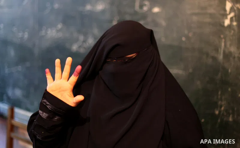 An Egyptian woman shows his ink-stained finger after casting his vote in the final stage of a referendum draft constitution in Cairo, on December 22, 2012. Egyptians are voting in the final round of a referendum on a new...