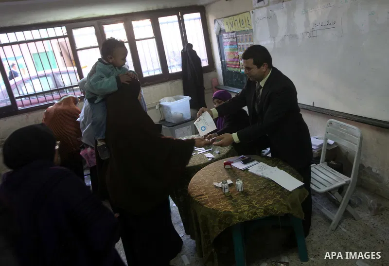 Egyptian women casts her ballot at a polling station during the second round of a referendum on a new draft constitution in Giza, south of Cairo, on December 22, 2012. Egyptians are voting in the final round of a referen...