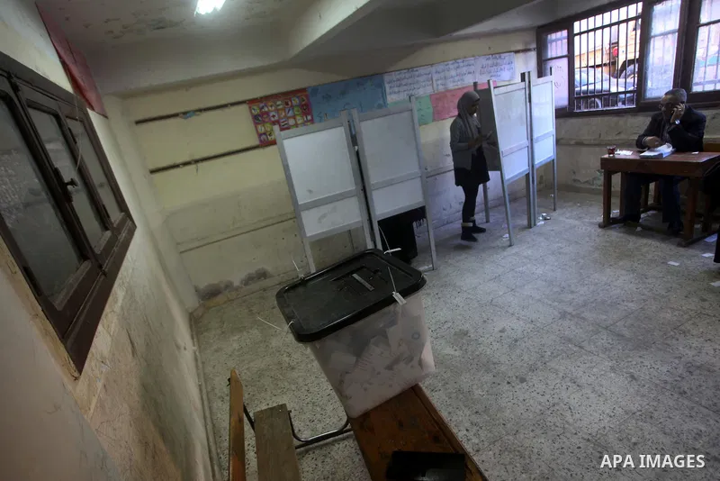 An Egyptian woman casts her ballot at a polling station during the second round of a referendum on a new draft constitution in Giza, south of Cairo, on December 22, 2012. Egyptians are voting in the final round of a refe...