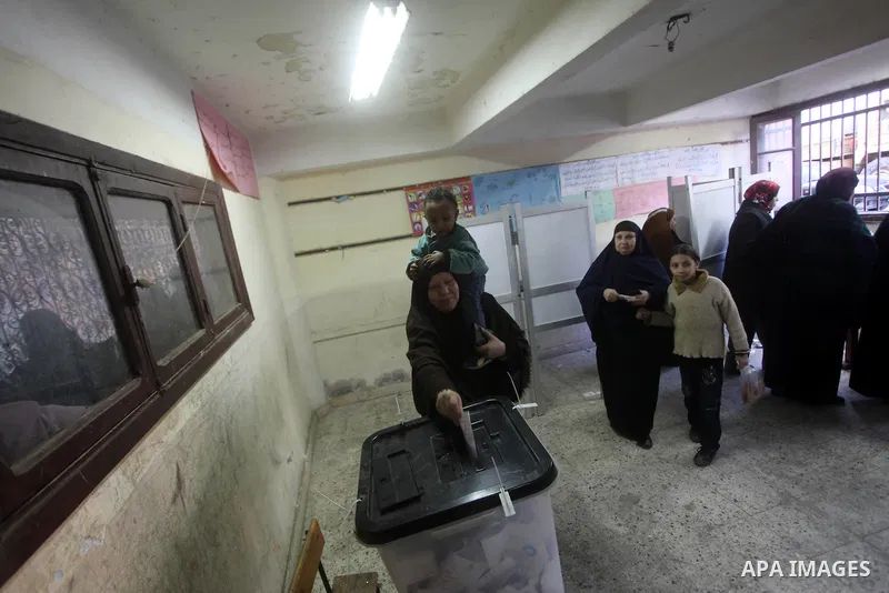 An Egyptian woman casts her ballot at a polling station during the second round of a referendum on a new draft constitution in Giza, south of Cairo, on December 22, 2012. Egyptians are voting in the final round of a refe...