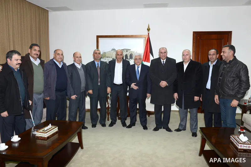 Palestinian President Mahmoud Abbas meets with the members of Olympic delegation in the West Bank city of Ramallah on 22 December 2012. Photo by Thaer Ganaim
