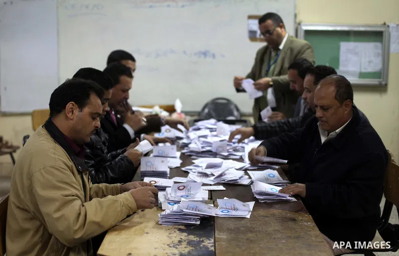 Officials count ballots after polls closed in Giza, south of Cairo, on December 22, 2012. Egyptians are voting in the final round of a referendum on a new constitution championed by President Mohamed Morsi and his Islami...