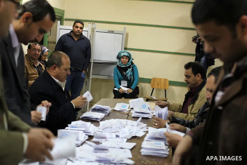 Officials count ballots after polls closed in Giza, south of Cairo, on December 22, 2012. Egyptians are voting in the final round of a referendum on a new constitution championed by President Mohamed Morsi and his Islami...