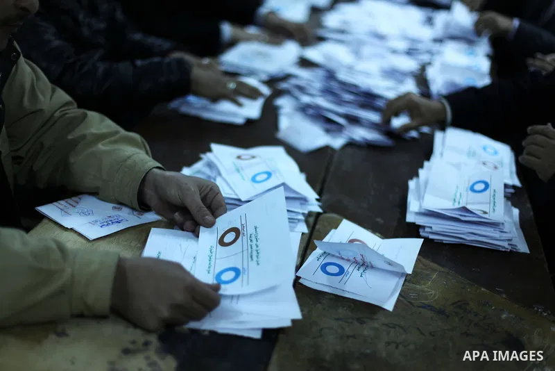 Officials count ballots after polls closed in Giza, south of Cairo, on December 22, 2012. Egyptians are voting in the final round of a referendum on a new constitution championed by President Mohamed Morsi and his Islami...