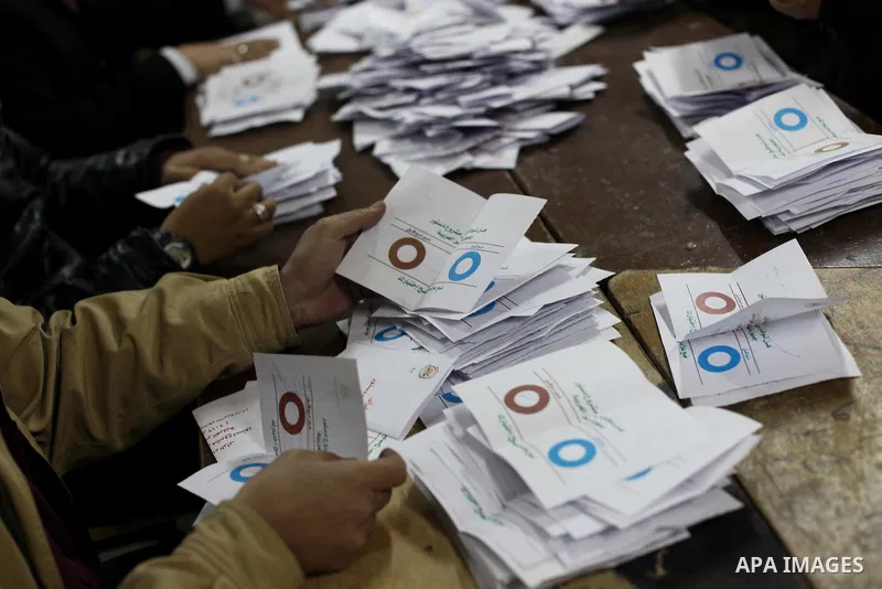 Officials count ballots after polls closed in Giza, south of Cairo, on December 22, 2012. Egyptians are voting in the final round of a referendum on a new constitution championed by President Mohamed Morsi and his Islami...