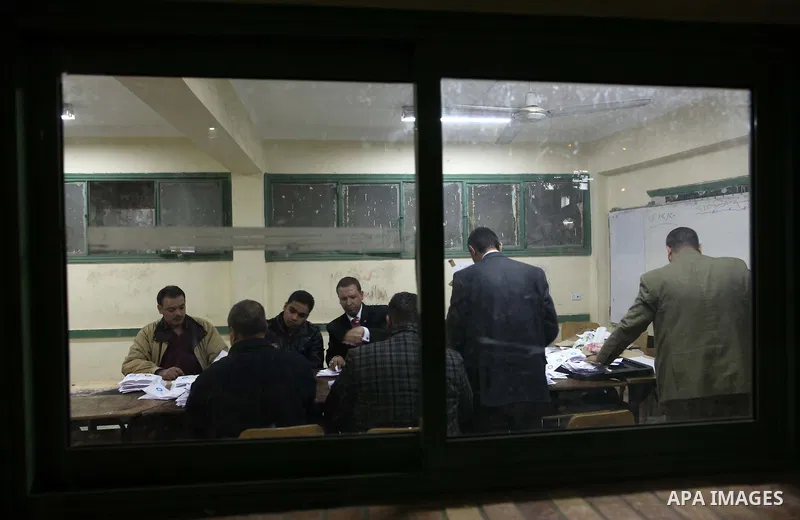 Officials count ballots after polls closed in Giza, south of Cairo, on December 22, 2012. Egyptians are voting in the final round of a referendum on a new constitution championed by President Mohamed Morsi and his Islami...