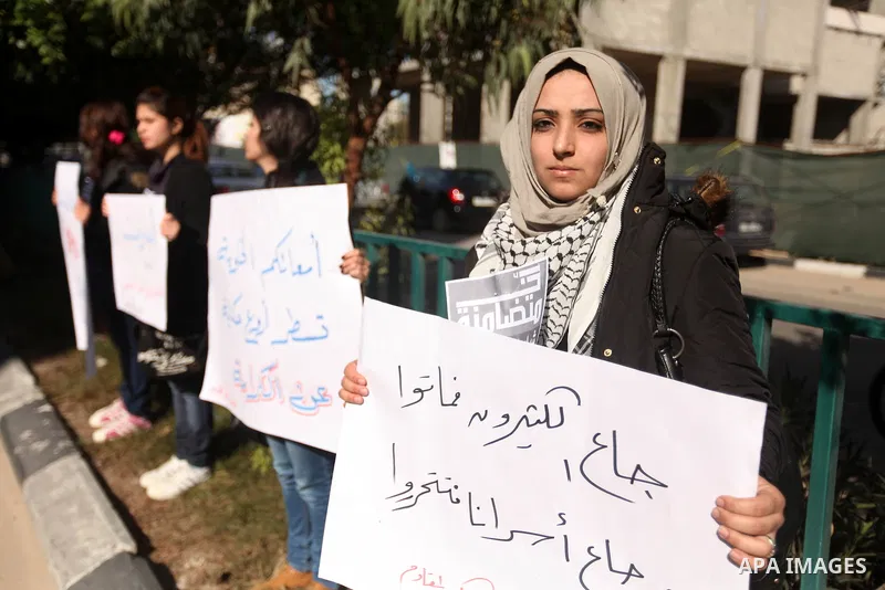 Palestinians youth hold a poster to show his support for Palestinian prisoners currently being held in Israeli jails, some of whom are on hunger strike, in Gaza city, 23, 2012. Photo by Majdi Fathi