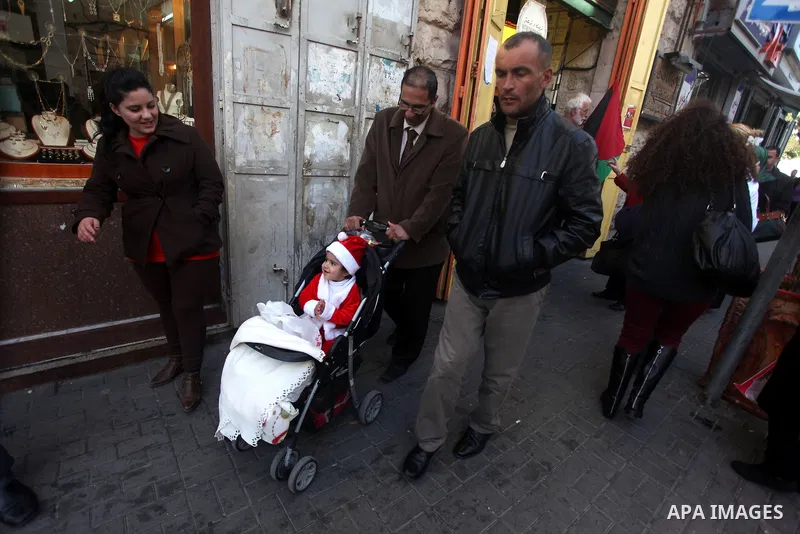 Palestinian Family prepares for the upcoming Christmas festivities in the West Bank city of Ramallah on 23 December 2012 .Christmas is celebrated Christians across the globe on December 25 every year. Photo by Issam Rima...
