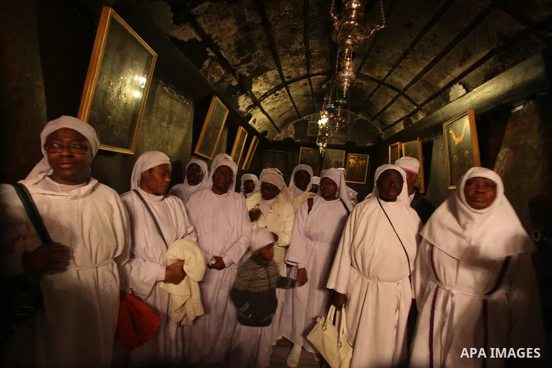 Pilgrims are seen near the 'Grotto,' where Christians believe the Virgin Mary gave birth to Jesus Christ, in the Church of the Nativity, in the West Bank town of Bethlehem on Christmas Day, 24 December 2012. Photo by Iss...