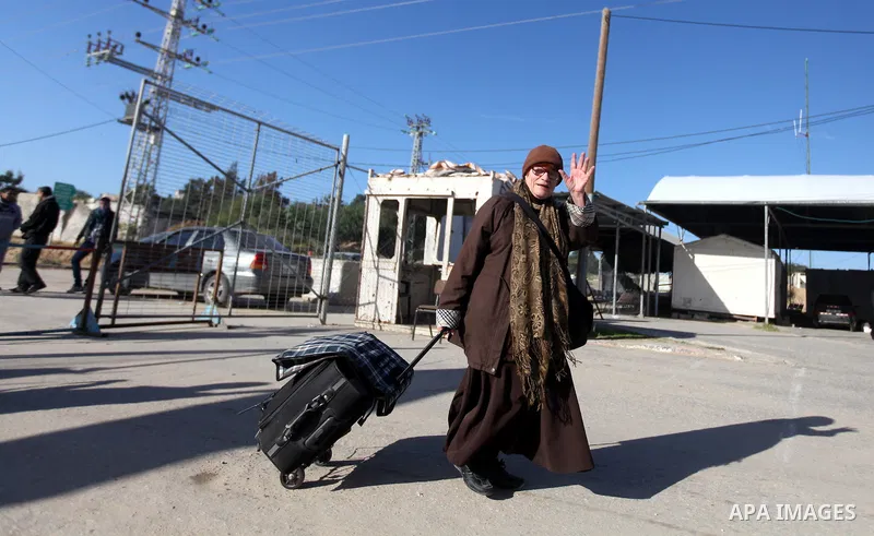 A Palestinian Christian walks towards Erez crossing in the northern Gaza Strip on Dec. 24, 2012 after Israel granted 557 permits for Christians from the isolated and impoverished territory to travel to the West Bank town...