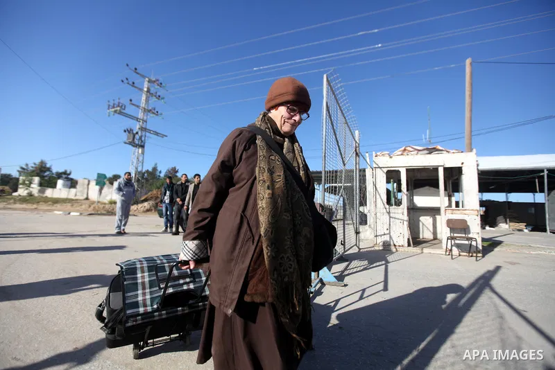 A Palestinian Christian walks towards Erez crossing in the northern Gaza Strip on Dec. 24, 2012 after Israel granted 557 permits for Christians from the isolated and impoverished territory to travel to the West Bank town...