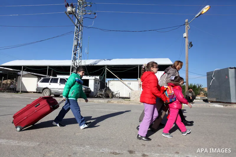 Palestinian Christians walk towards Erez crossing in the northern Gaza Strip on Dec. 24, 2012 after Israel granted 557 permits for Christians from the isolated and impoverished territory to travel to the West Bank town o...