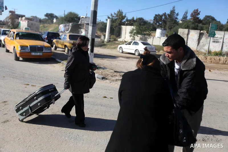 A Palestinian Christian walks towards Erez crossing in the northern Gaza Strip on Dec. 24, 2012 after Israel granted 557 permits for Christians from the isolated and impoverished territory to travel to the West Bank town...