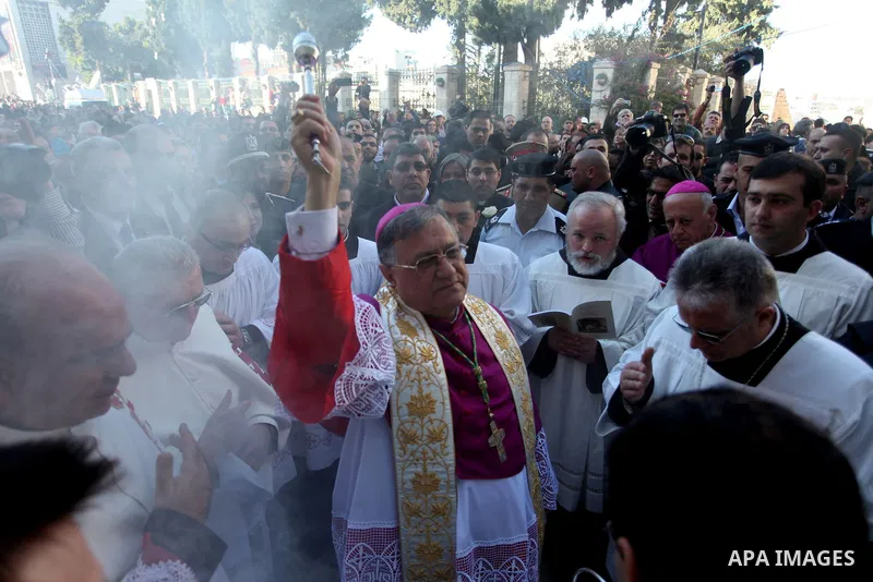 The Latin Patriarch of Jerusalem, Fouad Twal, arrives to Manger Square as he make his way to the Church of the Nativity, where Christians believe the Virgin Mary gave birth to Jesus Christ, in the West Bank town of Bethl...
