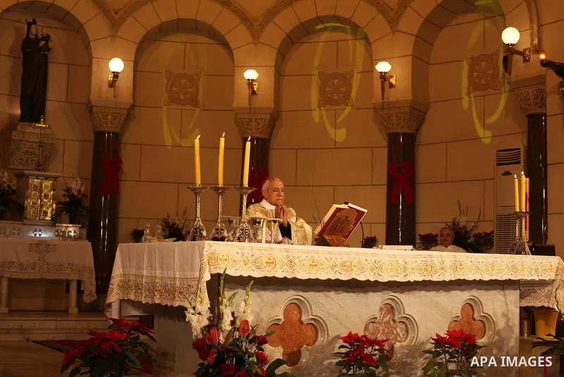 A Christian priest celebrates Christmas mass in Cairo, on December 24, 2012. Photo by Ashraf Amra