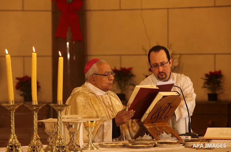A Christian priest celebrates Christmas mass in Cairo, on December 24, 2012. Photo by Ashraf Amra