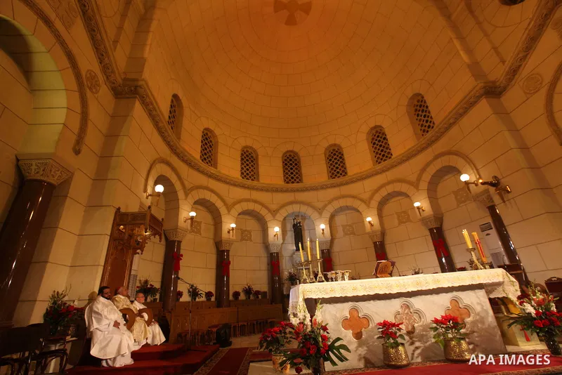 A Christian priest celebrates Christmas mass in Cairo, on December 24, 2012. Photo by Ashraf Amra