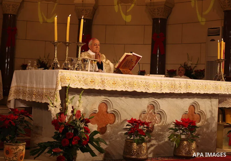 A Christian priest celebrates Christmas mass in Cairo, on December 24, 2012. Photo by Ashraf Amra