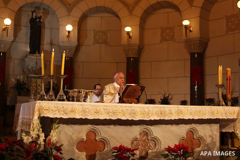 A Christian priest celebrates Christmas mass in Cairo, on December 24, 2012. Photo by Ashraf Amra