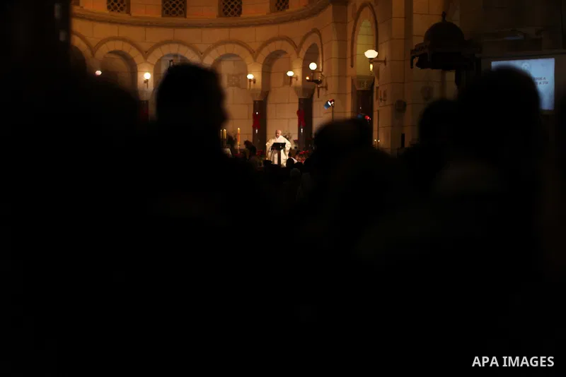 A Christian priest celebrates Christmas mass in Cairo, on December 24, 2012. Photo by Ashraf Amra