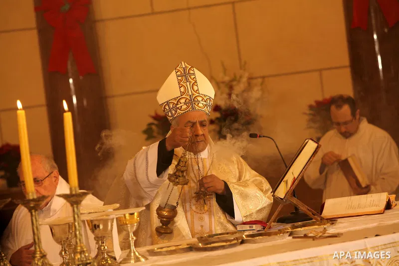 A Christian priest celebrates Christmas mass in Cairo, on December 24, 2012. Photo by Ashraf Amra