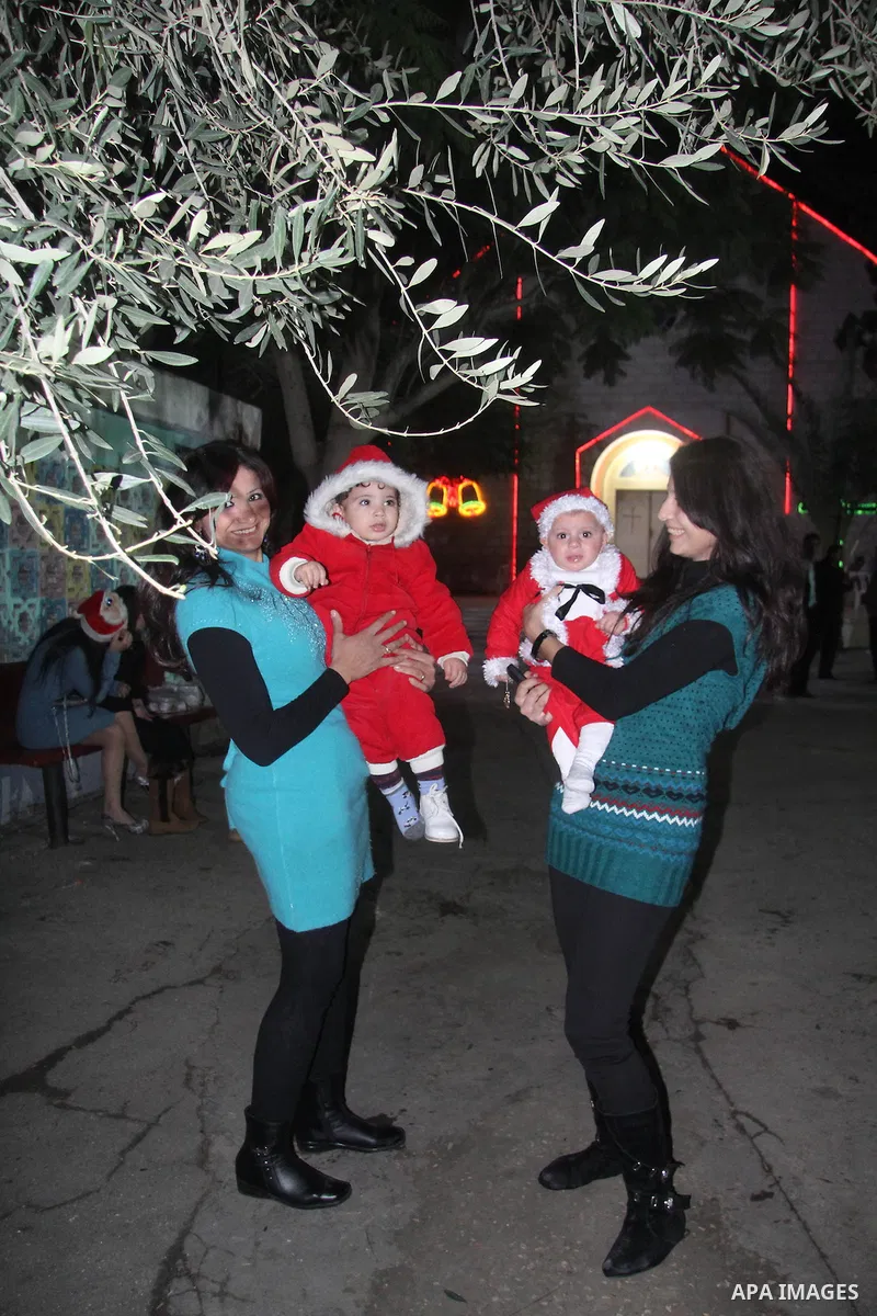 Palestinians Christian take part in the celebrations at a church of Deir Latin, during Christmas celebrations in Gaza city, on December 24, 2012. Photo by Ezz al-Zanoon