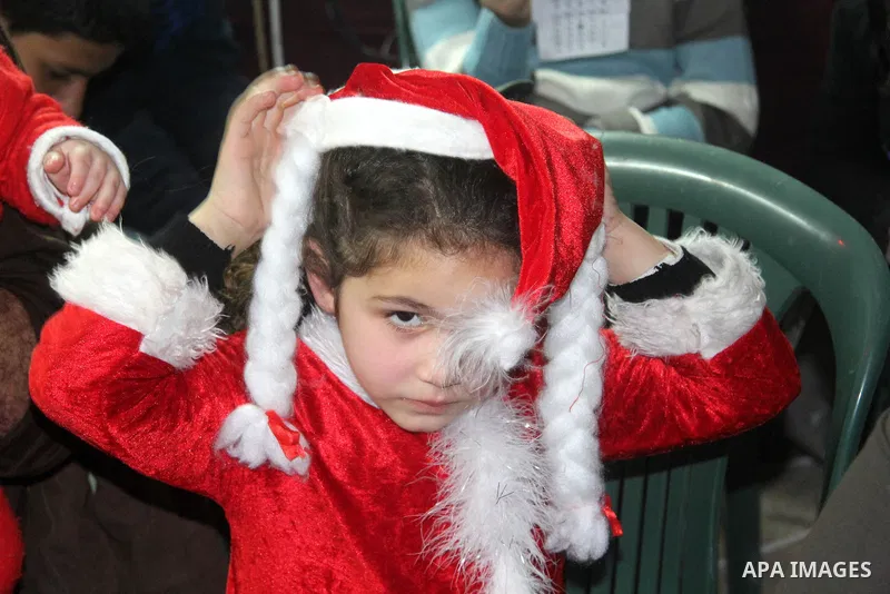 A Palestinian child dressed as Santa Claus during Christmas celebrations intside the Church of Deir Latin in Gaza city, on December 24, 2012. Photo by Ezz al-Zanoon