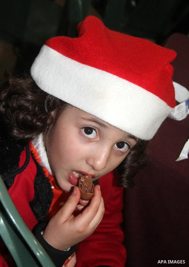 A Palestinian child dressed as Santa Claus during Christmas celebrations intside the Church of Deir Latin in Gaza city, on December 24, 2012. Photo by Ezz al-Zanoon