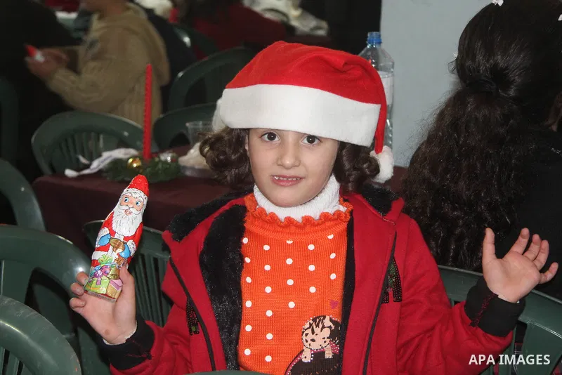 A Palestinian child dressed as Santa Claus during Christmas celebrations intside the Church of Deir Latin in Gaza city, on December 24, 2012. Photo by Ezz al-Zanoon